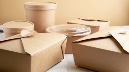 paper containers for takeaway food, isolated on a wooden table