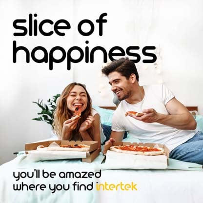 A man and woman eating pizza in bed