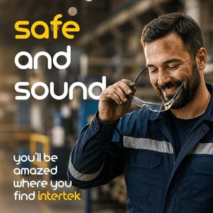 A man in a construction uniform putting on his safety glasses